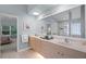 The main bathroom features double sinks, a framed mirror, a glass block shower and lots of storage space at 224 Bluestone Pl, Casselberry, FL 32707