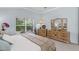 The main bedroom provides backyard views from the window, neutral decor and an ensuite bathroom at 224 Bluestone Pl, Casselberry, FL 32707