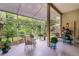 Relaxing screened patio featuring stylish tiled floors, comfortable seating, and lush garden views at 224 Bluestone Pl, Casselberry, FL 32707