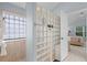 The main bathroom shower area features a glass block wall and a window for natural lighting at 224 Bluestone Pl, Casselberry, FL 32707