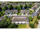 Aerial view of townhomes with a pond, fountain and lush community landscaping at 2743 River Landing Dr, Sanford, FL 32771