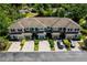 An aerial view of a row of townhomes surrounded by lush greenery at 2743 River Landing Dr, Sanford, FL 32771