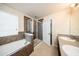 Bathroom showcasing a separate tub, glass shower and dual sink vanity with tile backsplash at 2743 River Landing Dr, Sanford, FL 32771