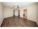Large bedroom featuring wood floors, neutral walls, ceiling fan and multiple doorways at 2743 River Landing Dr, Sanford, FL 32771