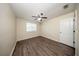 This bedroom has hardwood floors, ceiling fan, and a window providing natural light at 2743 River Landing Dr, Sanford, FL 32771