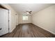 Spacious bedroom features wood flooring, a ceiling fan, and natural light from the window at 2743 River Landing Dr, Sanford, FL 32771