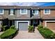 Inviting townhome with a one-car garage, brick drive, and manicured landscaping at 2743 River Landing Dr, Sanford, FL 32771