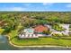 Aerial view of a community pool with a clubhouse, hot tub, landscaping, and a lake at 2769 Lido Key Dr, Kissimmee, FL 34747