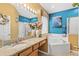 Colorful bathroom with a garden tub, vanity, and framed mirror at 2769 Lido Key Dr, Kissimmee, FL 34747