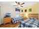 Bedroom with two beds, blue and white bedding, and a yellow accent wall at 2769 Lido Key Dr, Kissimmee, FL 34747