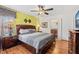 Bedroom with wood floors, ceiling fan, large bed, and en suite bathroom access at 2769 Lido Key Dr, Kissimmee, FL 34747