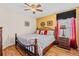 Bedroom with ceiling fan, wood floors, queen bed, and accent pillows at 2769 Lido Key Dr, Kissimmee, FL 34747