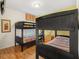 Bedroom with bunk beds, wood floors, and a striped window treatment at 2769 Lido Key Dr, Kissimmee, FL 34747