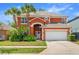 Charming two-story home featuring an attached two-car garage and well-manicured landscaping at 2769 Lido Key Dr, Kissimmee, FL 34747