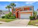 Charming two-story home featuring an attached two-car garage and mature landscaping at 2769 Lido Key Dr, Kissimmee, FL 34747