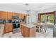 Spacious kitchen featuring a central island, stainless appliances, granite countertops, and access to a pool at 2769 Lido Key Dr, Kissimmee, FL 34747