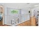 Upstairs landing featuring hardwood floors and a view of the living area below at 2769 Lido Key Dr, Kissimmee, FL 34747