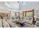 Open-concept living room with vaulted ceilings, a view of the kitchen and access to a patio at 2769 Lido Key Dr, Kissimmee, FL 34747