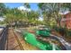 An outdoor mini golf course with different challenges, landscaping, and paving at 2769 Lido Key Dr, Kissimmee, FL 34747
