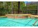 A clear, inviting swimming pool with a built in hot tub and lush surrounding landscape at 2769 Lido Key Dr, Kissimmee, FL 34747