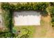 Aerial view of a meticulously maintained sand volleyball court surrounded by lush landscaping at 2769 Lido Key Dr, Kissimmee, FL 34747