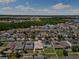Expansive aerial view showcases a home with solar panels surrounded by a well-maintained community and green spaces at 3138 Twin Shore Ln, Orlando, FL 32824