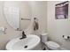 Cozy half bathroom featuring an oval mirror and a pedestal sink at 3138 Twin Shore Ln, Orlando, FL 32824