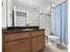 Neutral bathroom featuring wooden cabinets and a black countertop at 3138 Twin Shore Ln, Orlando, FL 32824