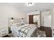 Bright bedroom with a wooden-accented bed, stylish decor, and sliding door access to the ensuite bathroom at 3138 Twin Shore Ln, Orlando, FL 32824