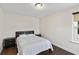 Comfortable bedroom with dark wood floors, a queen-sized bed, and natural light from a window at 3138 Twin Shore Ln, Orlando, FL 32824