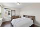 This well-lit bedroom has a dark wood floor and a queen sized bed at 3138 Twin Shore Ln, Orlando, FL 32824
