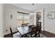 A dining room featuring a wooden table, stylish chandelier, and view into a modern kitchen at 3138 Twin Shore Ln, Orlando, FL 32824