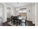 A dining room featuring a wooden table, stylish chandelier, and view of the front door at 3138 Twin Shore Ln, Orlando, FL 32824