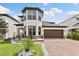 Charming home featuring a three-story tower, a two-car garage, and professional landscaping at 3138 Twin Shore Ln, Orlando, FL 32824