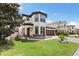 Charming two-story home boasts a well-manicured lawn, stone accents, and a welcoming arched entryway at 3138 Twin Shore Ln, Orlando, FL 32824