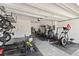 Garage converted to home gym featuring weight training equipment, an elliptical, and open space for exercise at 3138 Twin Shore Ln, Orlando, FL 32824