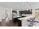 Modern kitchen featuring dark cabinetry, stainless steel appliances, an island, and pendant lighting at 3138 Twin Shore Ln, Orlando, FL 32824
