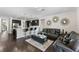 Spacious living room featuring dark hardwood floors, modern decor, and a breakfast bar at 3138 Twin Shore Ln, Orlando, FL 32824