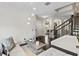 A living room featuring a white couch, stylish decor, and open access to the stairway and dining area at 3138 Twin Shore Ln, Orlando, FL 32824