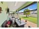 Covered patio with seating and view of the backyard and palm trees at 3138 Twin Shore Ln, Orlando, FL 32824