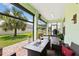 Inviting covered patio featuring brick pavers, comfortable seating, and a view of the lush backyard and palm trees at 3138 Twin Shore Ln, Orlando, FL 32824