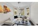 Bright sitting area with a white sectional couch, a large bay window, and hardwood floors at 3138 Twin Shore Ln, Orlando, FL 32824