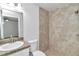 Well-lit bathroom featuring a vanity with sink and a tiled walk-in shower offering style and functionality at 3914 Sw 161St Loop, Ocala, FL 34473