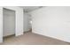 Light-filled bedroom with neutral carpet, white walls and a view of the kitchen at 3914 Sw 161St Loop, Ocala, FL 34473
