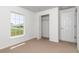 Well-lit bedroom with a closet, large window and plush carpeting at 3914 Sw 161St Loop, Ocala, FL 34473