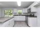 Bright kitchen featuring stainless steel appliances, white cabinets, and stone countertops at 3914 Sw 161St Loop, Ocala, FL 34473