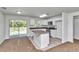 Modern kitchen with island, stainless appliances, granite countertops, and adjacent dining area at 3914 Sw 161St Loop, Ocala, FL 34473