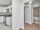 Galley kitchen featuring white cabinets, modern appliances, and adjacent dining area at 3914 Sw 161St Loop, Ocala, FL 34473
