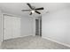 Clean, neutral bedroom with a ceiling fan, carpeted flooring, and a closet at 4070 Mcneil Rd, Apopka, FL 32703