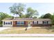 Charming single-story home features a brick accent, inviting front entrance, and well-maintained lawn at 4070 Mcneil Rd, Apopka, FL 32703